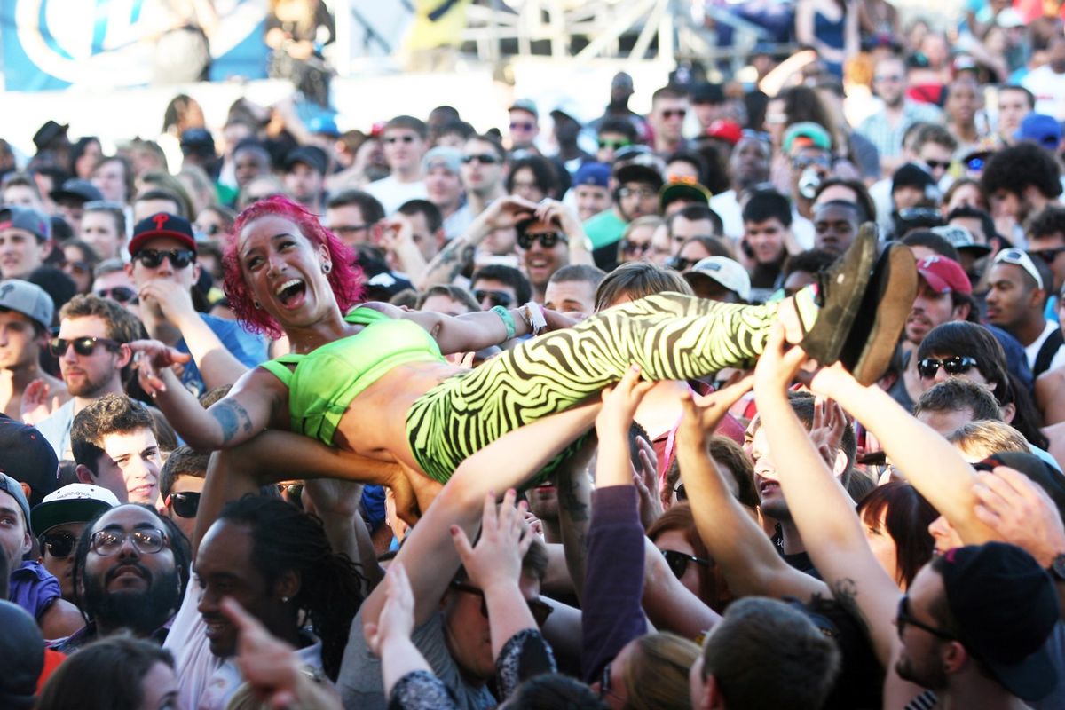 A backup dancer crowd surfs during the performance of Major Lazer at the Roots Picnic 2012 at Festival Pier on June 3, 2012 in Philadelphia, Pennsylvania. 