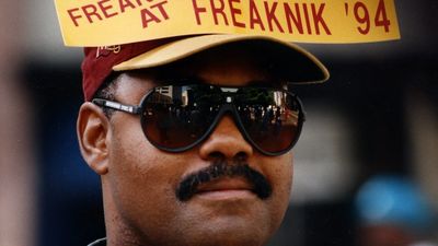 A man at Freaknik '94 wears a sign on his hat and sunglasses