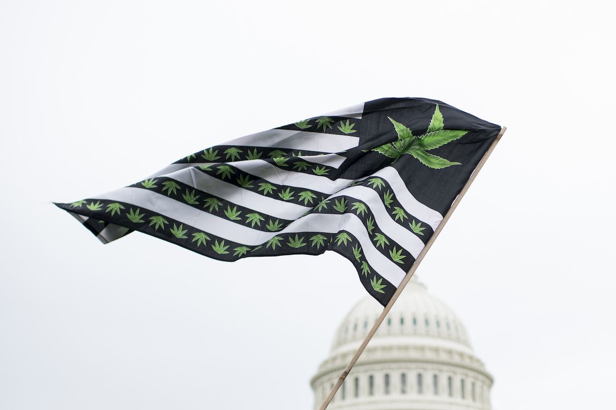 A U.S. flag redesigned with marijuana leaves blows in the wind as DCMJ.org holds a protest in front of the U.S. Capitol on Monday, April 24, 2017, to call on Congress to reschedule the drug classification of marijuana.