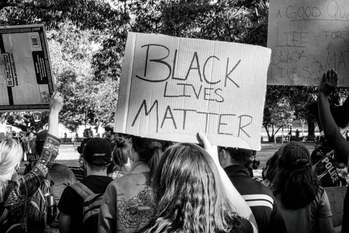 A woman holds a sign for BLM during a protest in Washington, DC