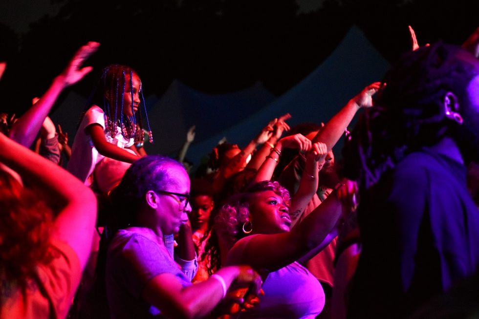 A young girl gets a great vantage point to enjoy Grandmaster Flash from a moving seat in the middle of the crowd at BAMSFest in Franklin Park on June 24, 2023.