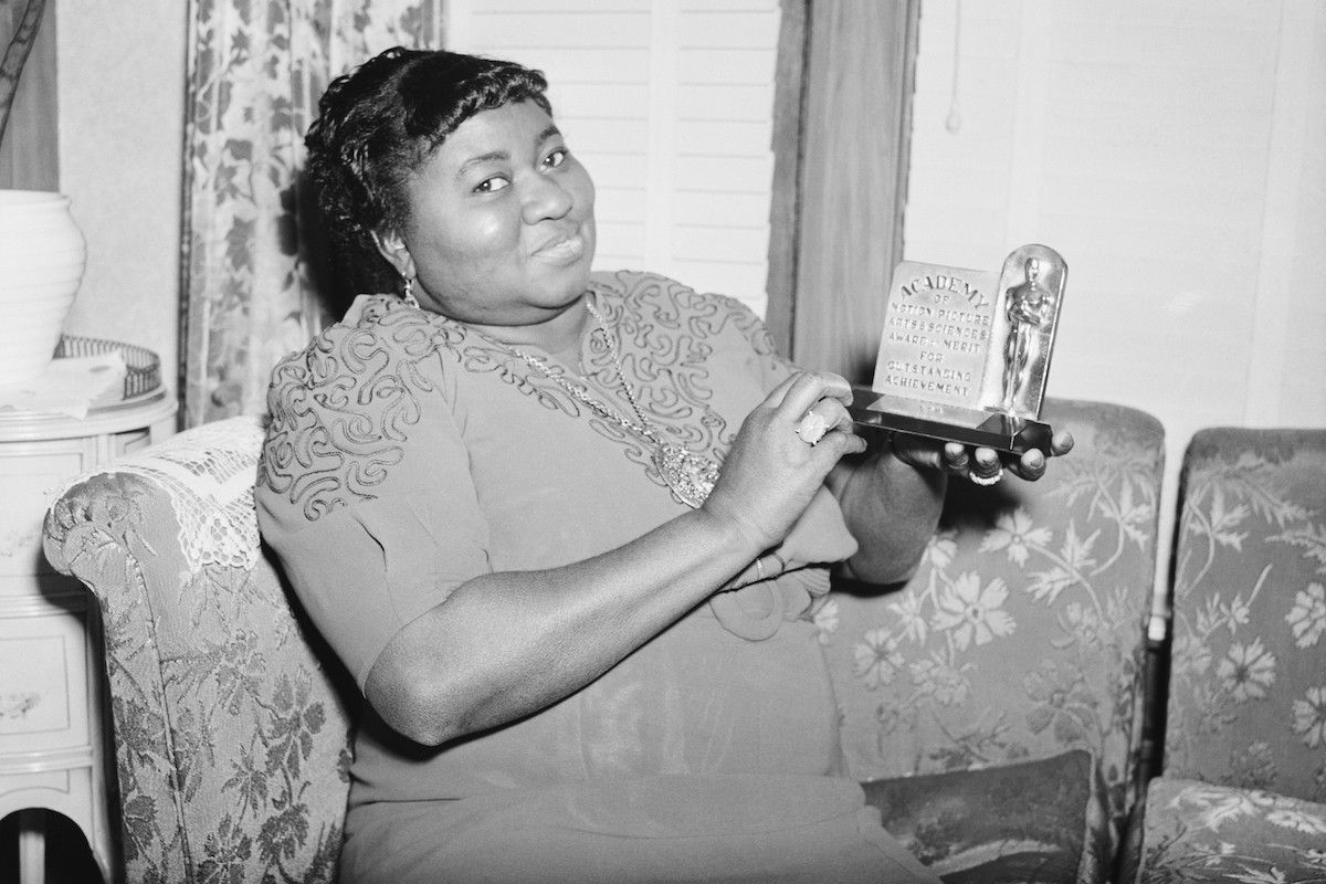 Actress Hattie Mc Daniel is shown with the statuette she received for her portrayal in "Gone With The Wind." The award was for Best Supporting Role by an Actress, and was made at the 12th annual Academy Awards ceremony.