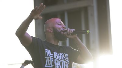 Common performs on stage with The Sounds of Blackness during the 1 year anniversary of the death of George Floyd