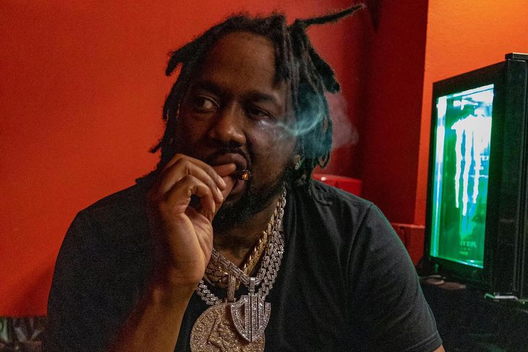 https://www.okayplayer.com/media-library/conway-the-machine-smoking-a-blunt-in-a-room-with-red-walls-won-t-he-do-it-press-photo.jpg?id=33647862&width=760&quality=90