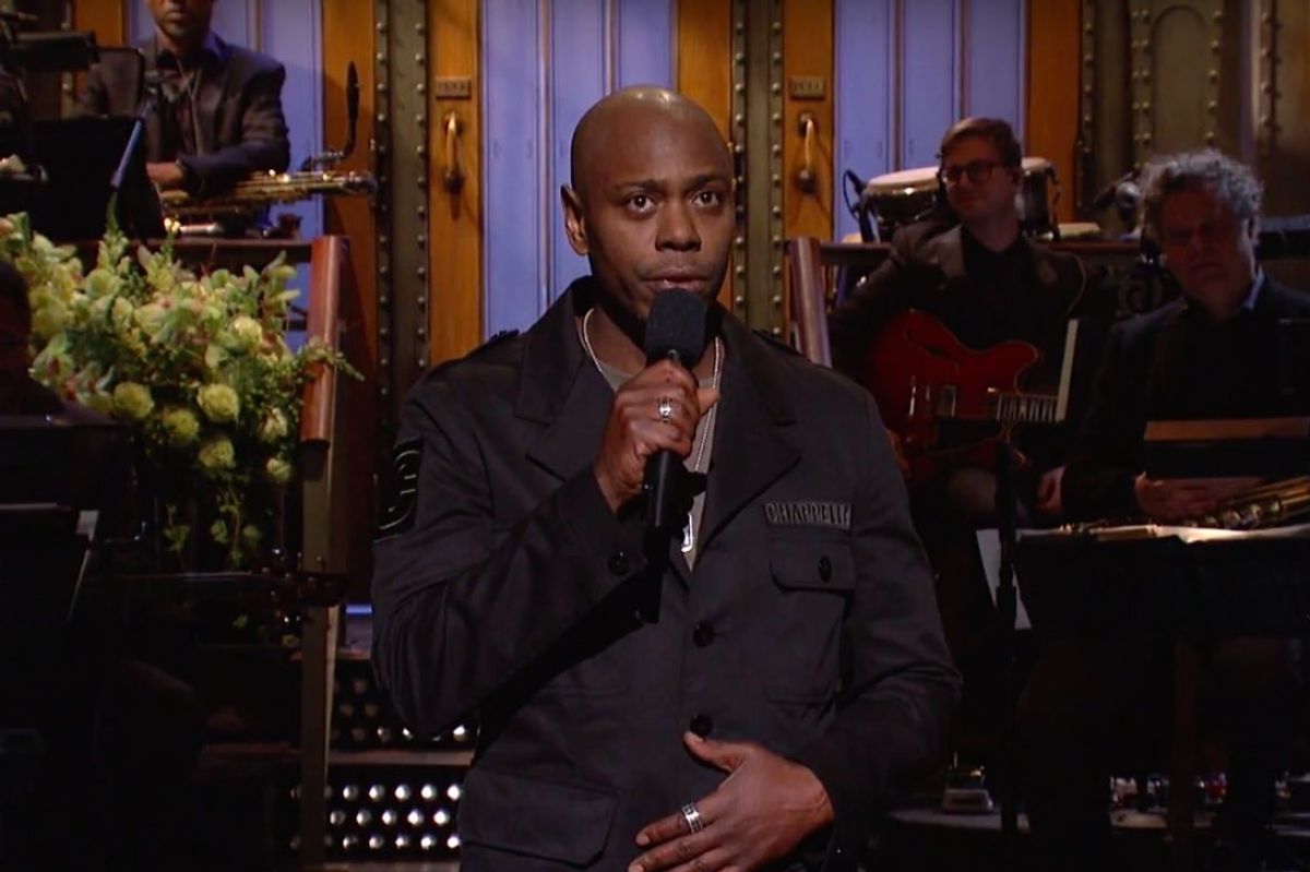 Dave Chappelle holding the mic