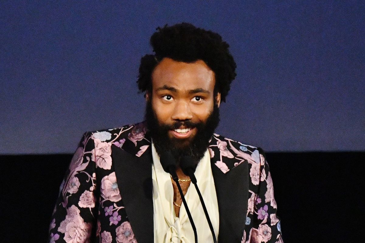 Donald Glover, wearing Gucci, speaks onstage during the 2019 LACMA Art + Film Gala .