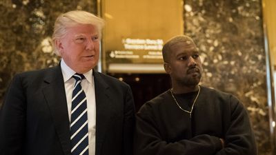 Donald Trump and Kanye West stand together in the lobby at Trump Tower,