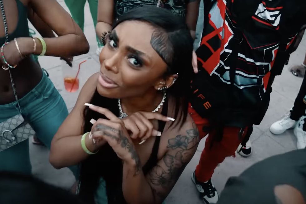 Female rapper Lay Bankz looks up into the camera