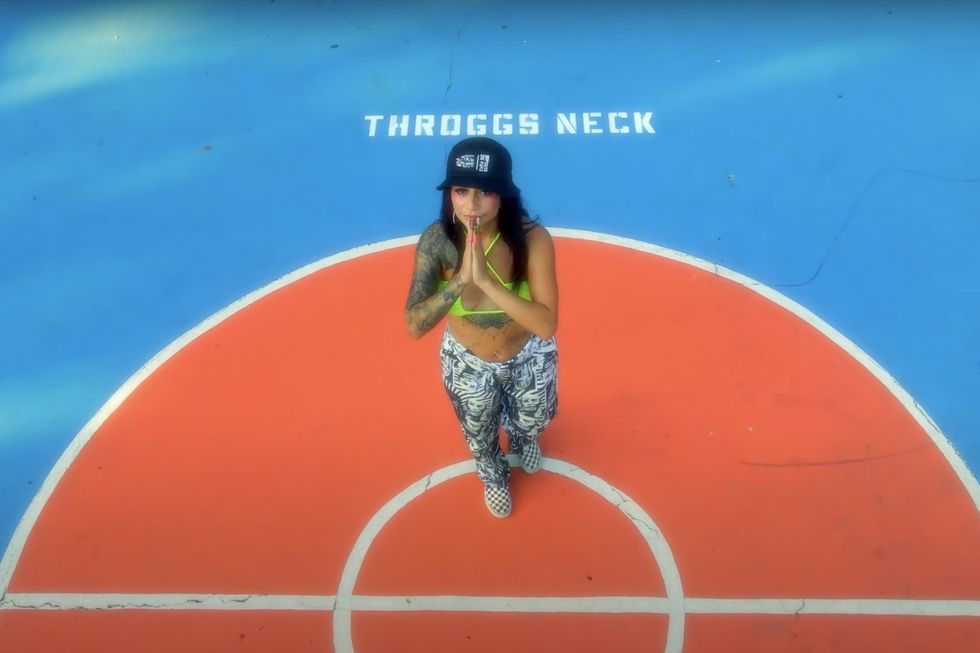 Female rapper vel nine out on a basketball court