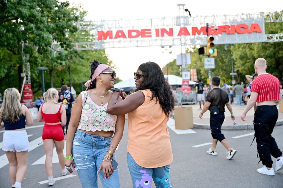 Festivalgoers pose by the festival entrance during 2022 Made In America at Benjamin Franklin Parkway on September 04, 2022 in Philadelphia, Pennsylvania.