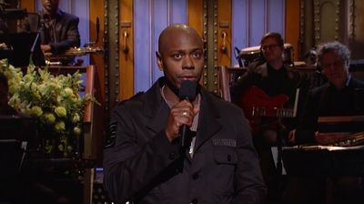 Dave Chappelle holding the mic