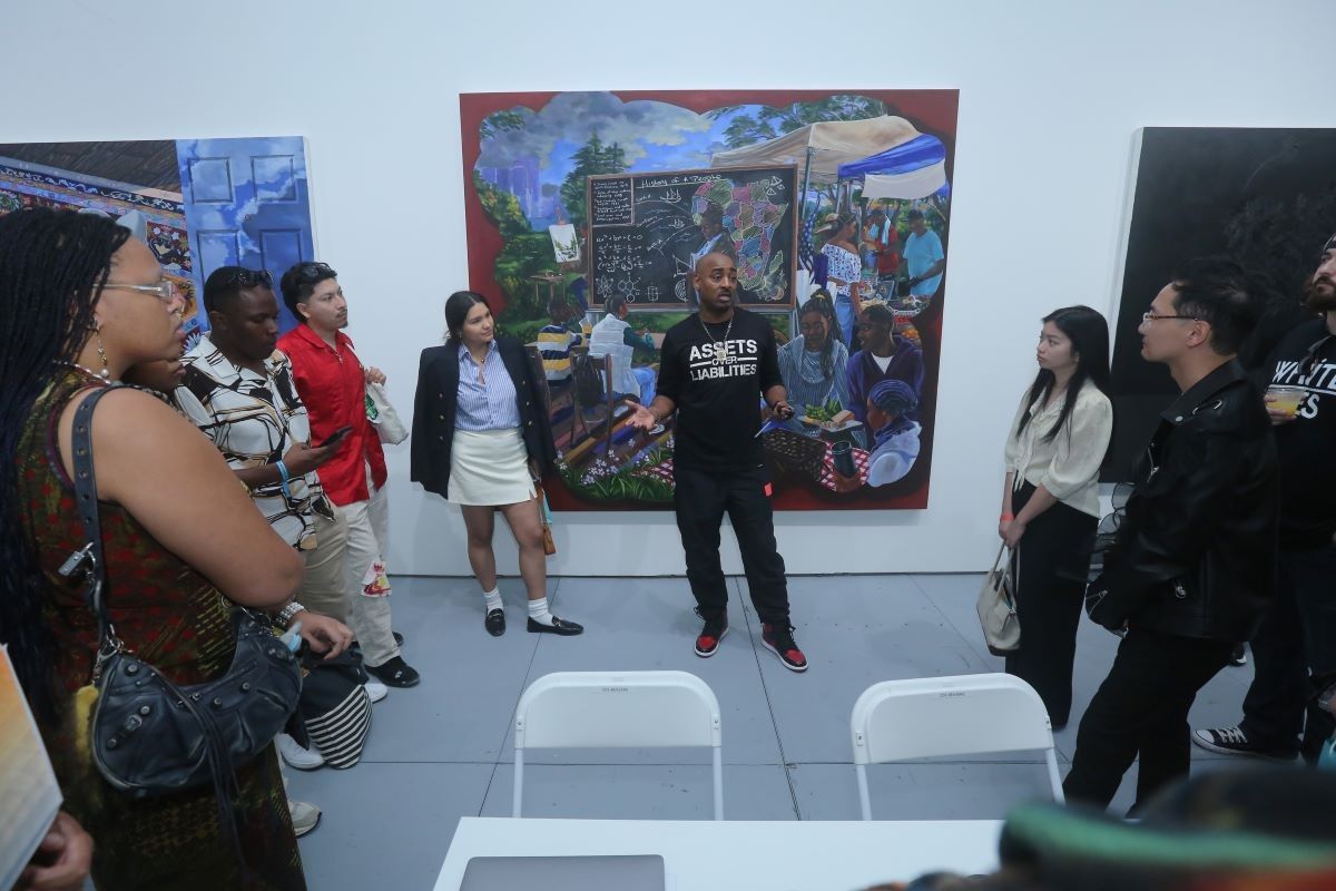 Gallerist Richard Beavers speaks to students with the Fashion For All Foundation at the Richard Beavers Gallery at SCOPE Art Fair as part of Art Basel Miami Beach on December 9, 2023 in Miami, Florida.