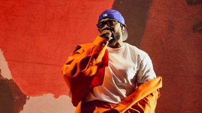 Kendrick Lamar with a blue dodgers hat
