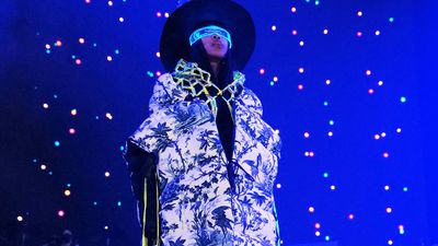 Erykah Badu performing in all blue and glasses 