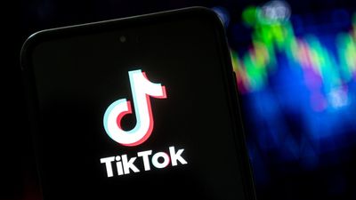 In this photo illustration a tiktok logo seen displayed on a
