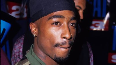 2Pac in a camo shirt and durag. 
