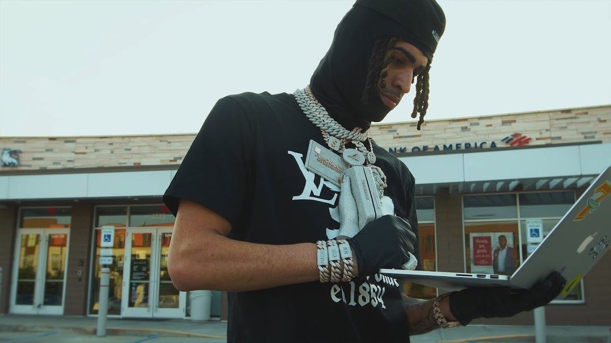 rapper wearing mask holding chain