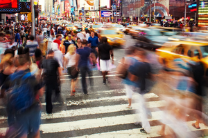 ​Photo by Andy Ryan of blurry people moving quickly across a New York city crosswalk. 