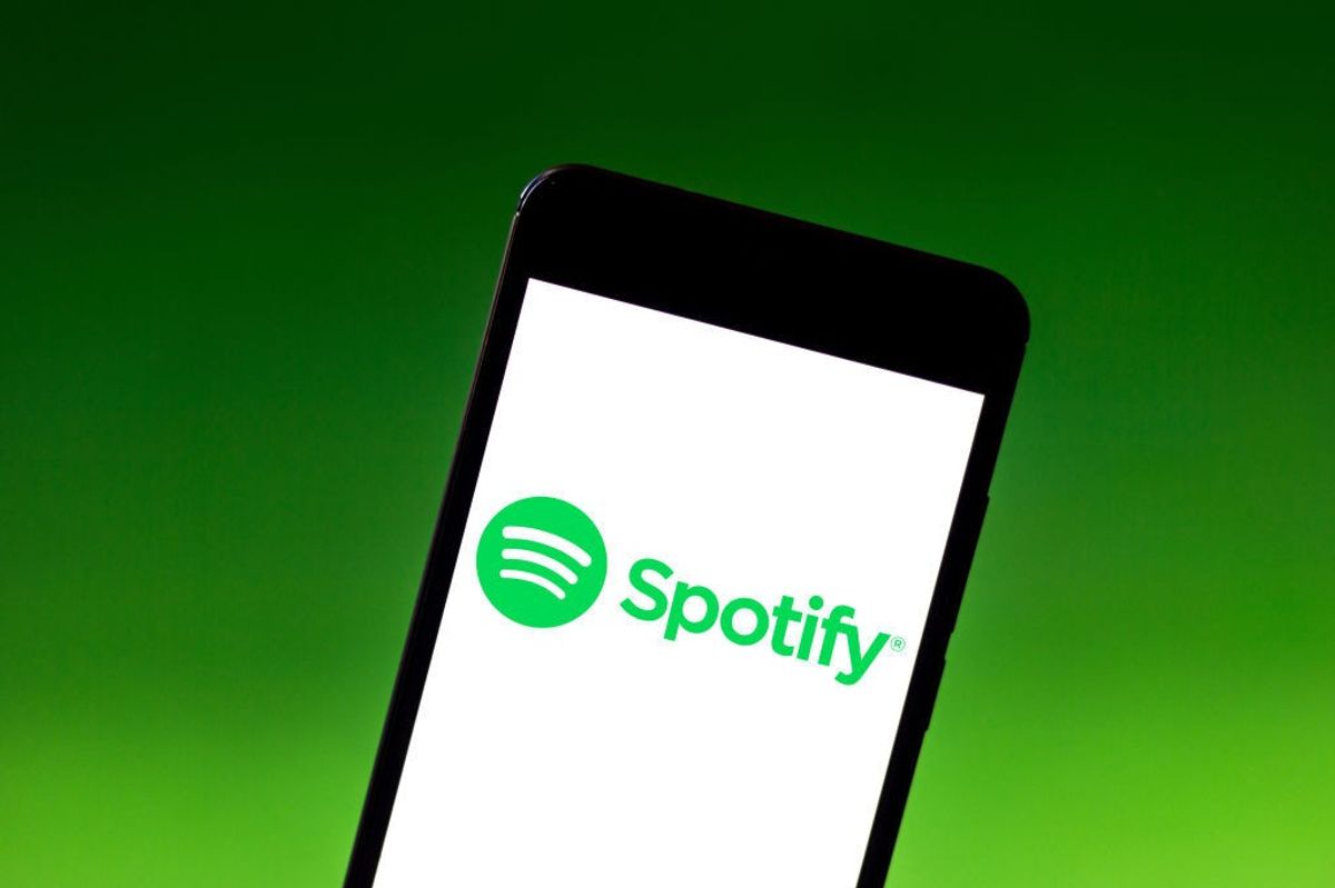 In this photo illustration the spotify logo is seen