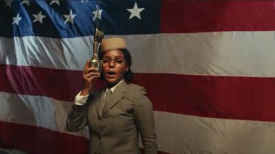 Janelle Monáe in front of american flag