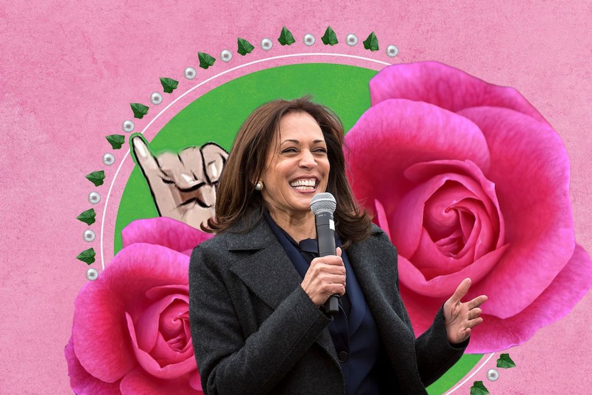 Kamala Harris holding mic in front of pink flower