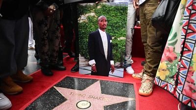 A portrait of US rapper Tupac Shakur is displayed next to his newly unveiled star during his Hollywood Walk of Fame star ceremony in Hollywood, California, on June 7, 2023.