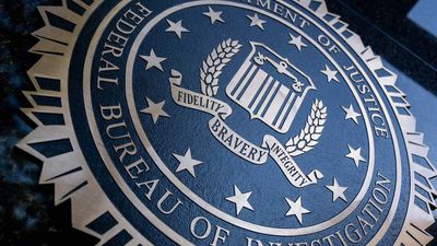 A seal reading "Department of Justice Federal Bureau of Investigation" is displayed on the J. Edgar Hoover FBI building in Washington, DC, o August 9, 2022.