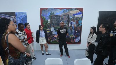 Gallerist Richard Beavers speaks to students with the Fashion For All Foundation at the Richard Beavers Gallery at SCOPE Art Fair as part of Art Basel Miami Beach on December 9, 2023 in Miami, Florida.