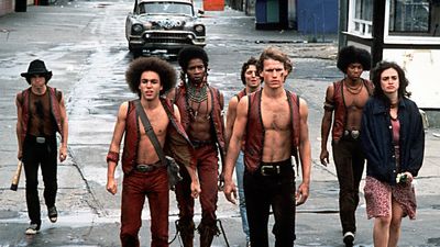 In a scene from the film 'The Warriors' (directed by Walter Hill), members of the titular gang walk west along Bowery Street in Coney Island, New York, New York, 1979.