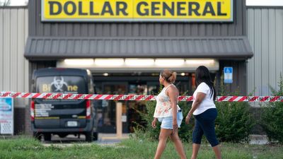 People walk past the Dollar General store where three people were shot and killed the day before on August 27, 2023 in Jacksonville, Florida.