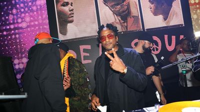 Q-Tip wearing red glasses at a party 