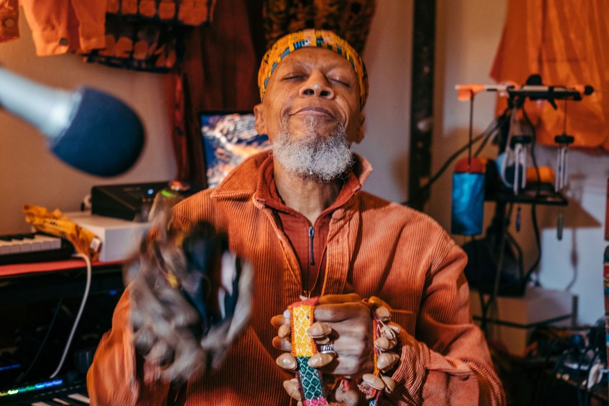 Multi-instrumentalist  Laraaji  plays Peruvian cacho seed pods in his music room inside his Harlem apartment.
