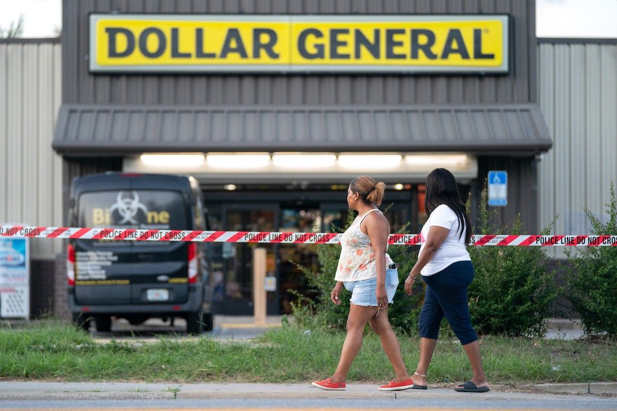 People walk past the Dollar General store where three people were shot and killed the day before on August 27, 2023 in Jacksonville, Florida.