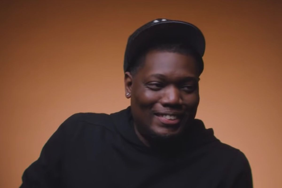 Screenshot of Michael Che against a bronze background in the trailer for the upcoming HBO Max series, 'That Damn Michael Che.'