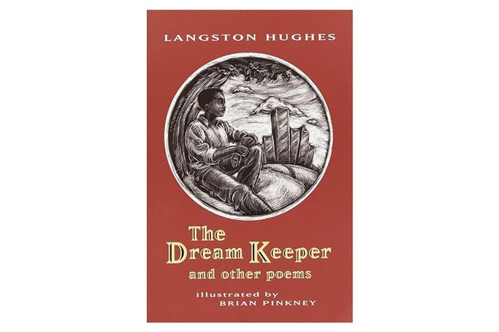 The cover of the dream keeper shows a black boy leaning against a tree with a city skyline in the background.