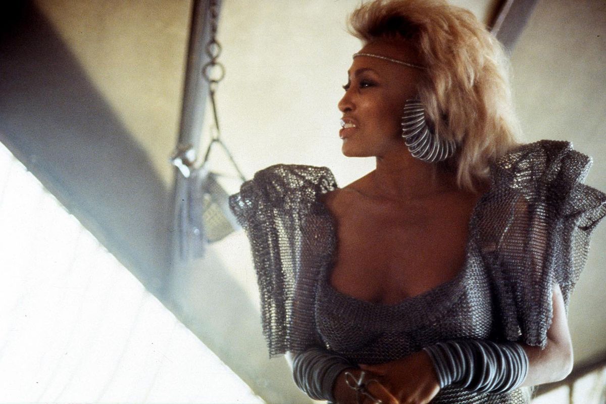 Tina Turner wearing silver attire in a scene from the film 'Mad Max Beyond Thunderdome,' 1985.