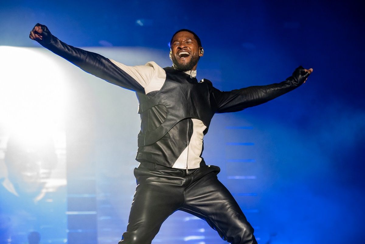 Usher performing, looking happy  