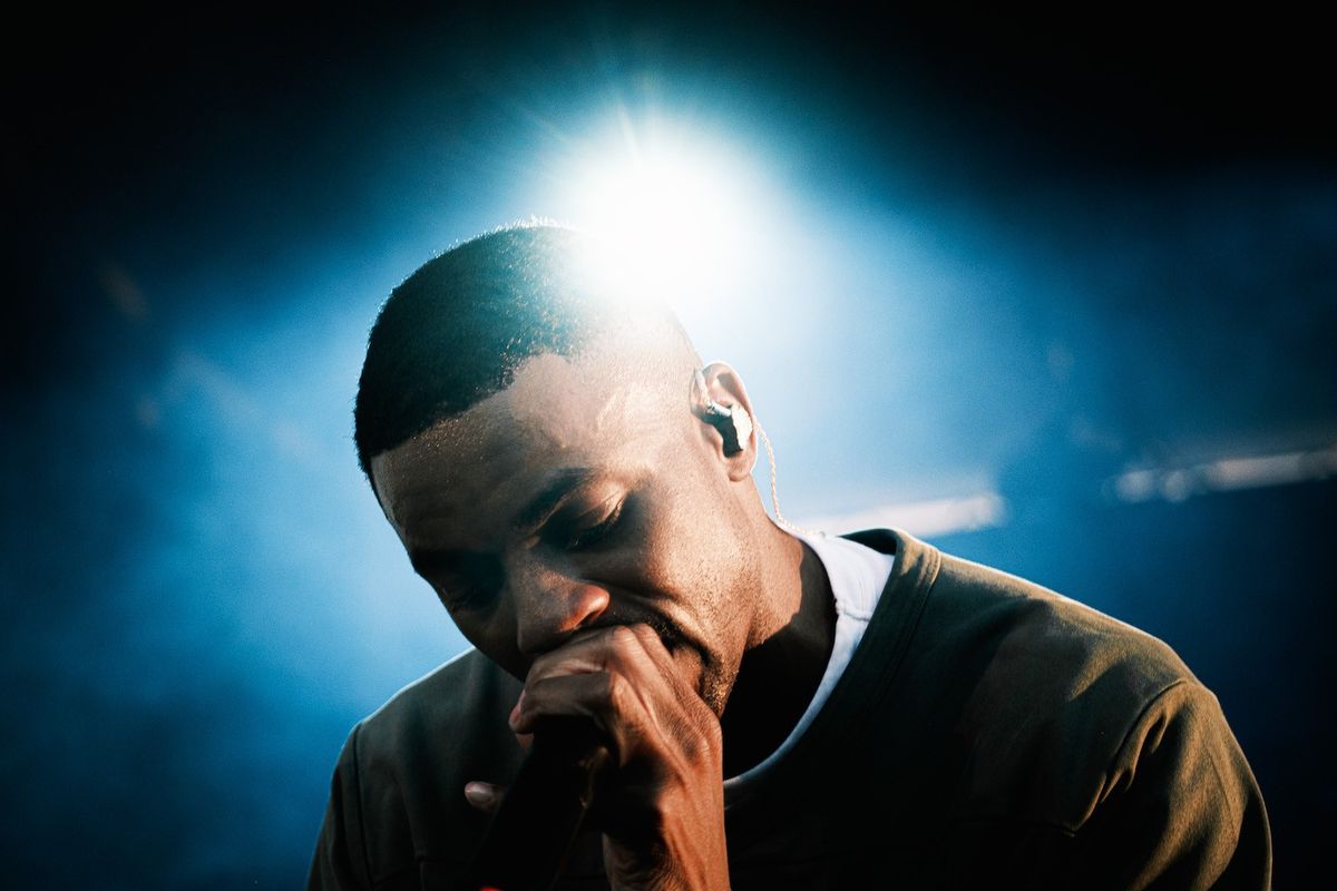 Vince Staples in front of a blue light 