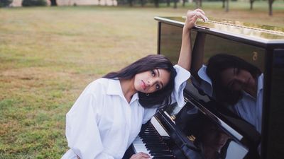 Woman in white playing piano