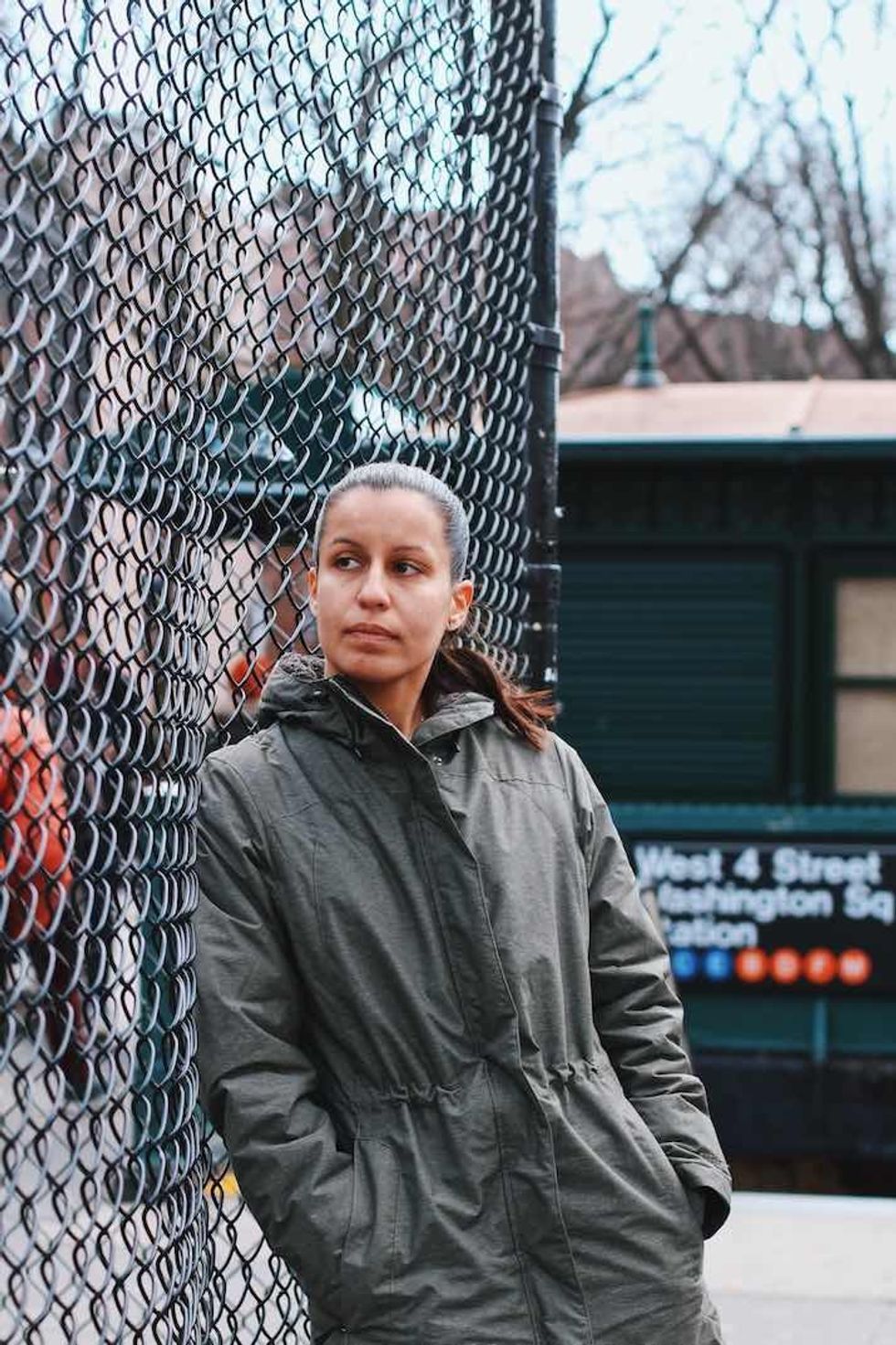 Woman in front of gate talks about stop-and-frisk