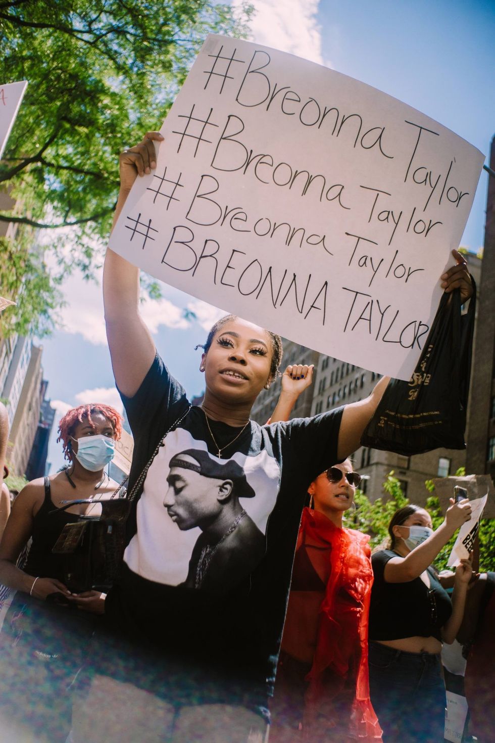 Women protester holding up sign for Breonna Taylor during protest