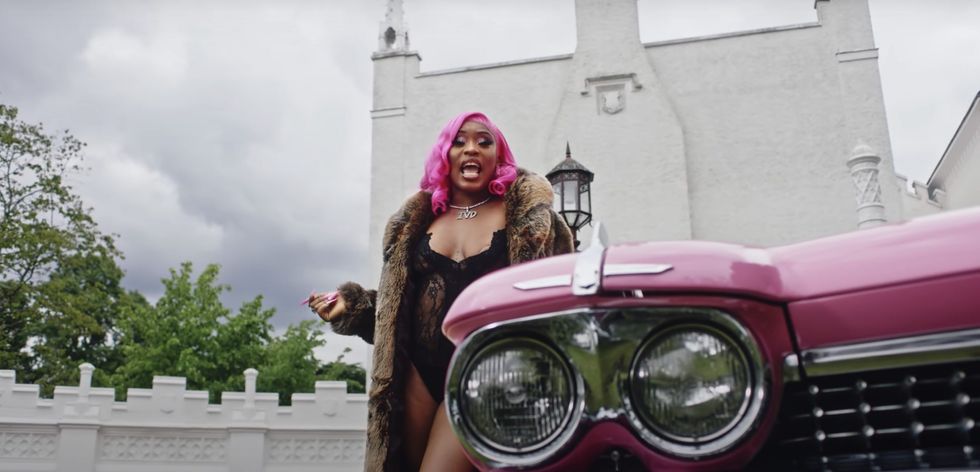 female British drill rapper with pink hair and a pink car