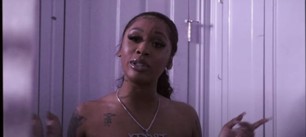 female rapper Treety with chain and tattoos