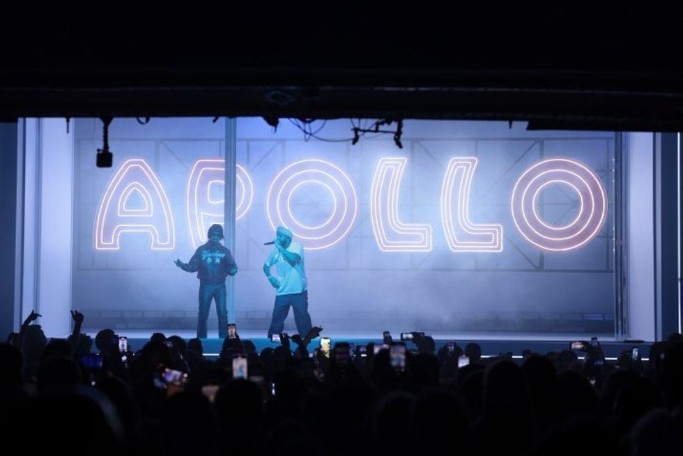 Drake on stage with 21 Savage with the classic Apollo sign behind them