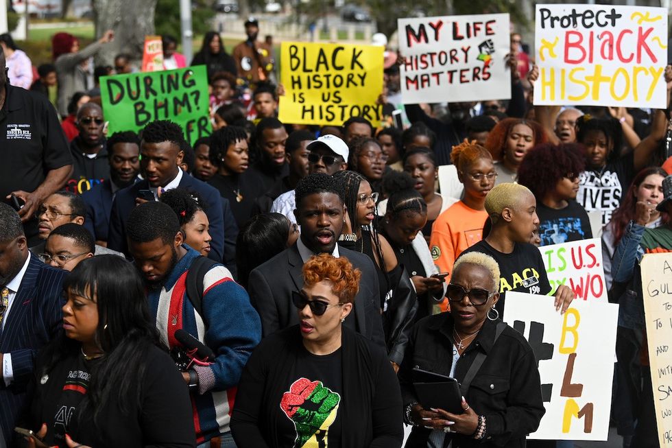 Demonstrators protest Florida Governor Ron DeSantis plan to eliminate Advanced Placement courses on African American studies in high schools as they stand outside the Florida State Capitol on February 15, 2023 in Tallahassee, Florida ( Joshua Lott/The Washington Post via Getty Images).