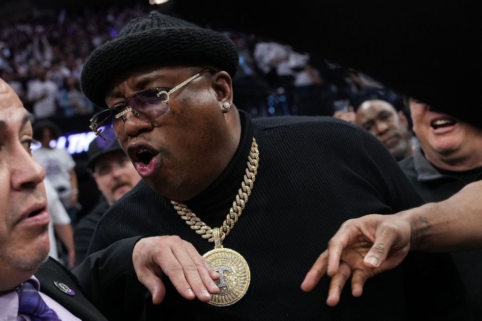 Earl Tywone Stevens Sr., known as the rapper E-40, yells at arena security personnel before being escorted from courtside seating during Game One of the Western Conference First Round Playoffs between the Golden State Warriors and Sacramento Kings at the Golden 1 Center on April 15, 2023 in Sacramento, California (phot by Loren Elliott/Getty Images).